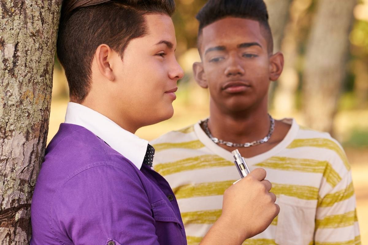 two teens vaping